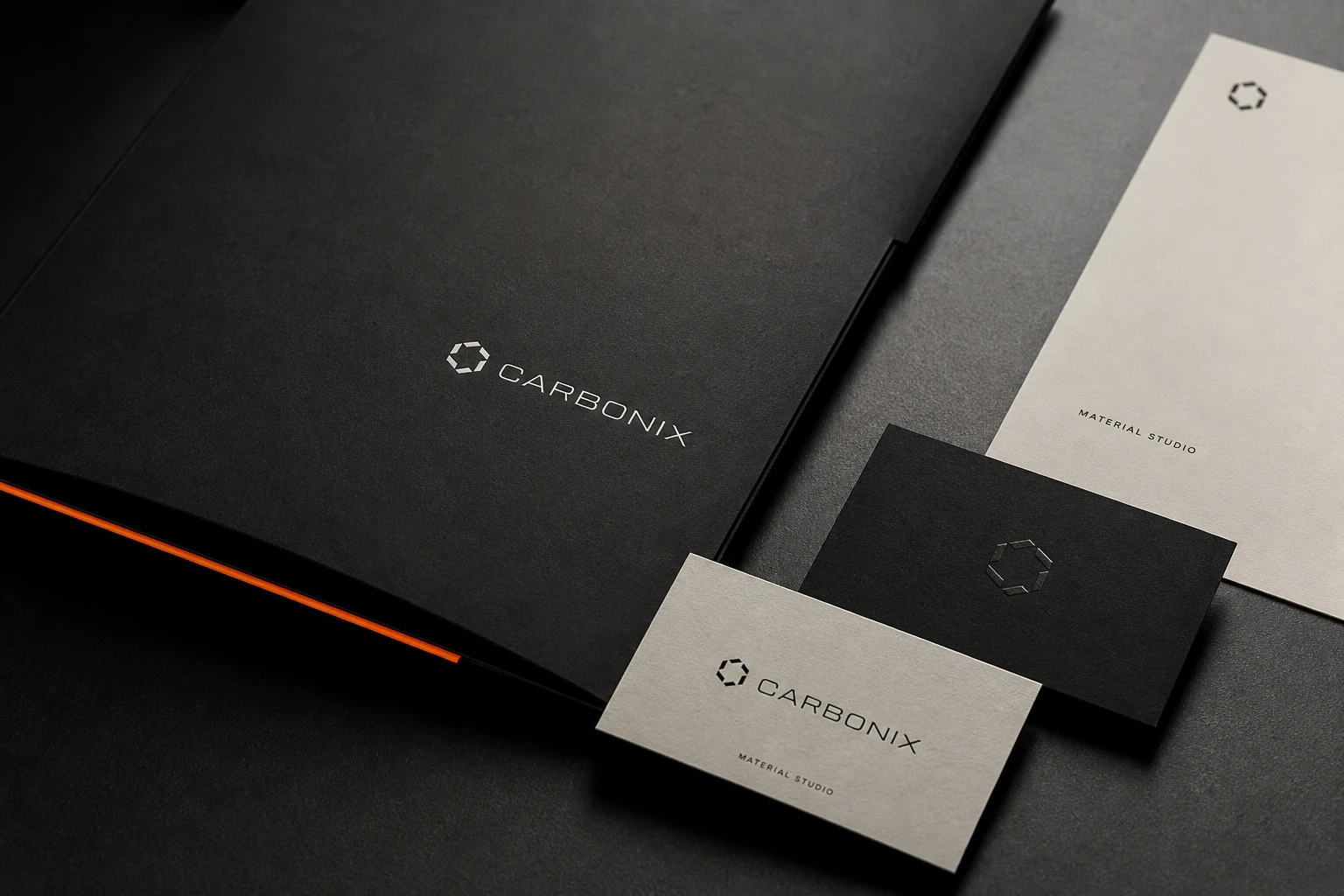 Carbonix letterhead, envelopes, folder and business cards in charcoal and mineral white.
