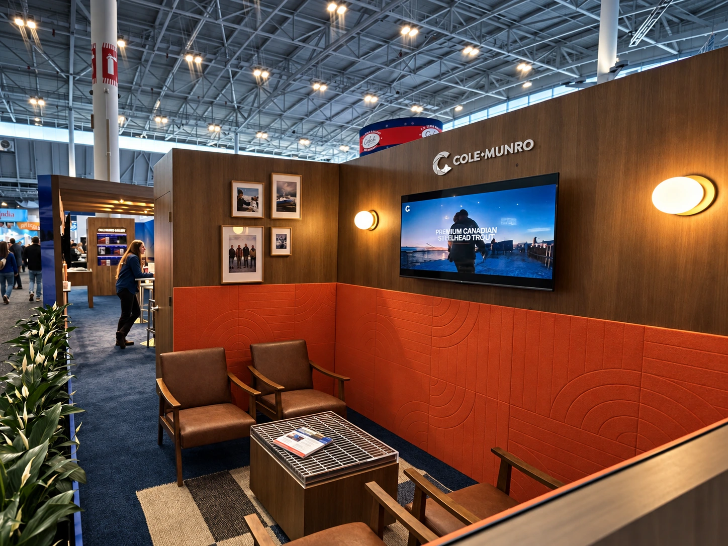 Cole Munro lounge with leather chairs, orange relief panels and a film screen.