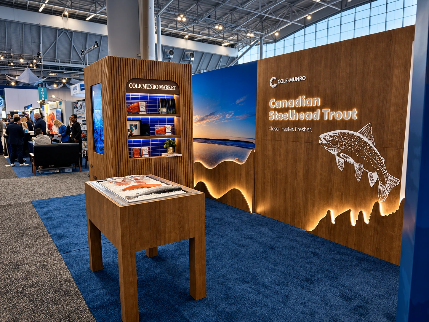 Cole Munro’s wood-clad exhibition booth with blue water imagery, integrated screens and a product display.