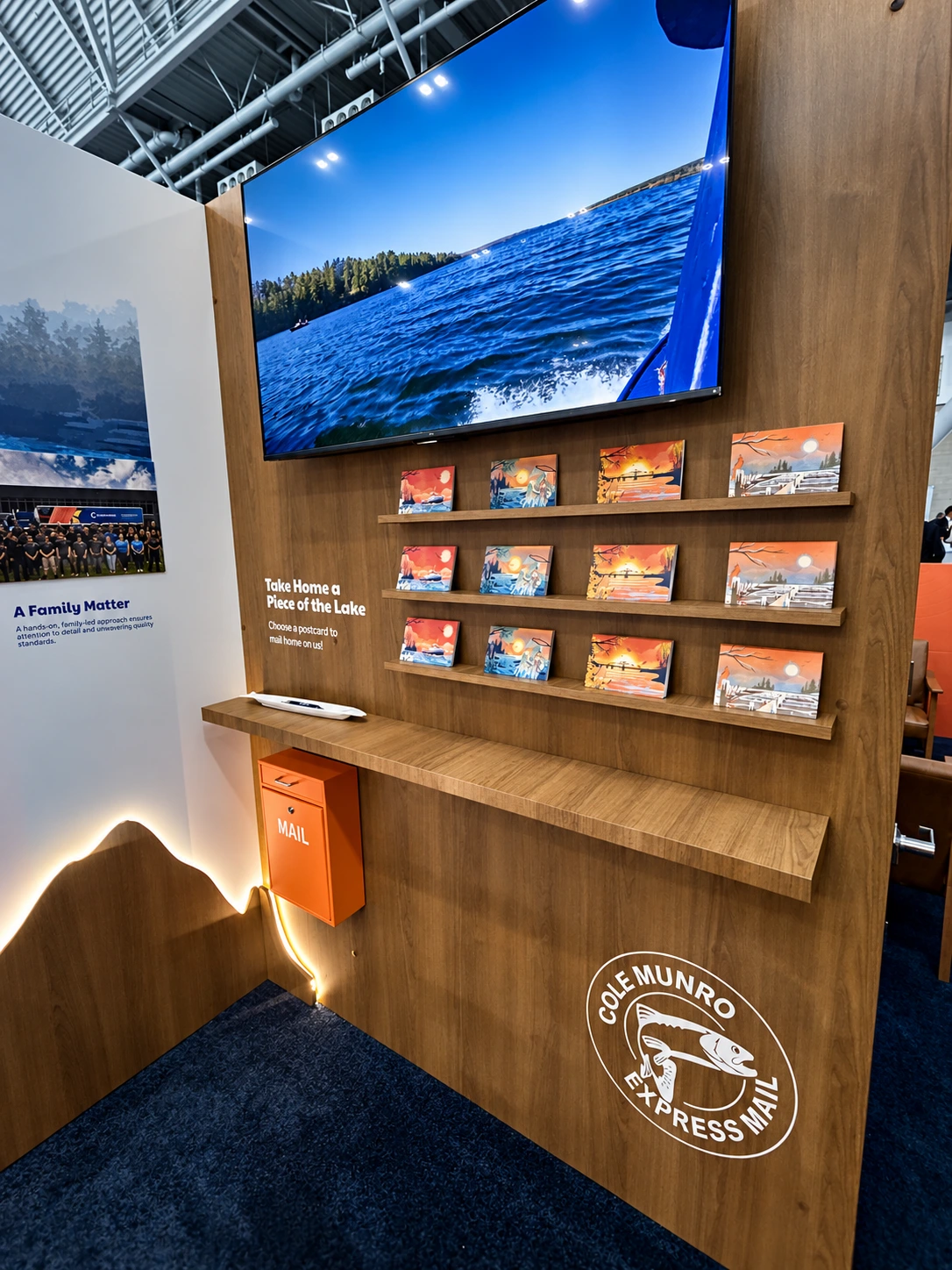 Postcard station with illustrated cards, an orange mailbox and a screen showing Canadian waters.