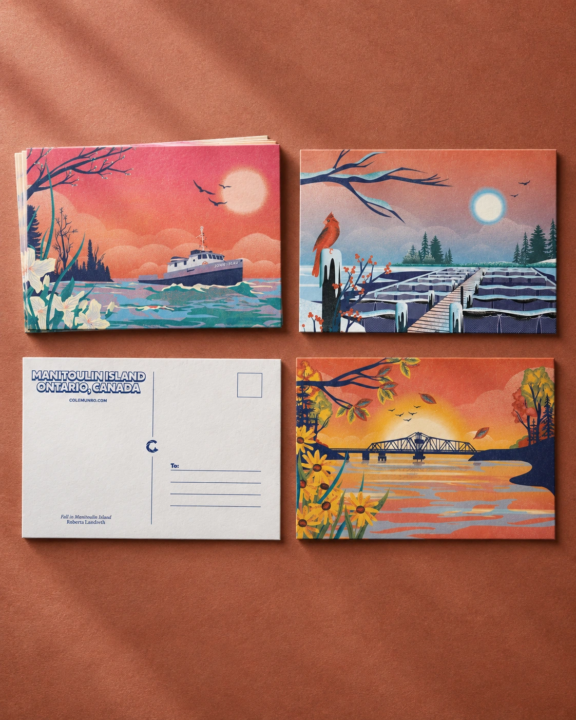 Illustrated Manitoulin Island postcards showing a boat, winter fish farm and autumn bridge, with a postcard reverse credited to Roberta Landreth.