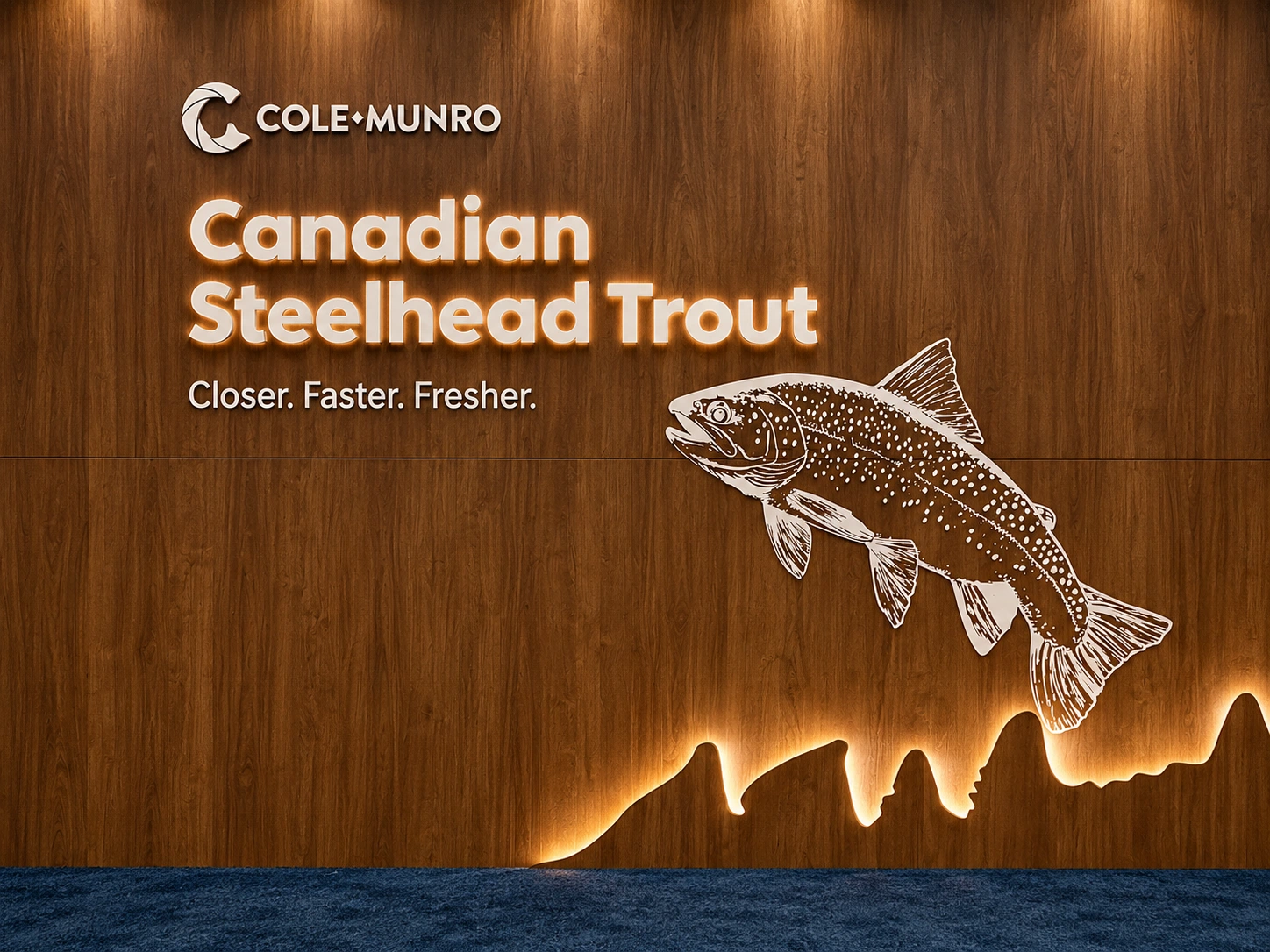 Cole Munro logo, illuminated Canadian Steelhead Trout lettering and a trout illustration on wood.