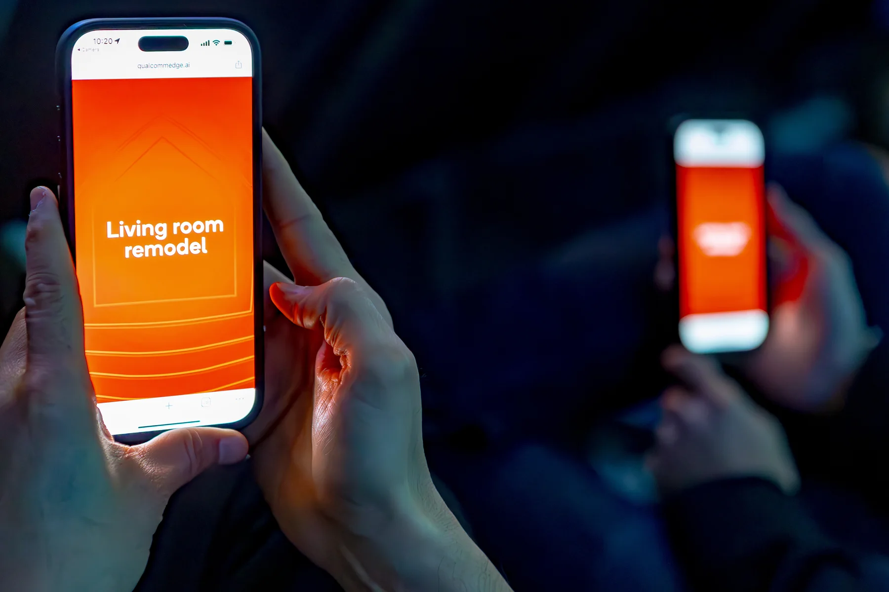 An attendee holds a phone displaying the living room remodel experience.