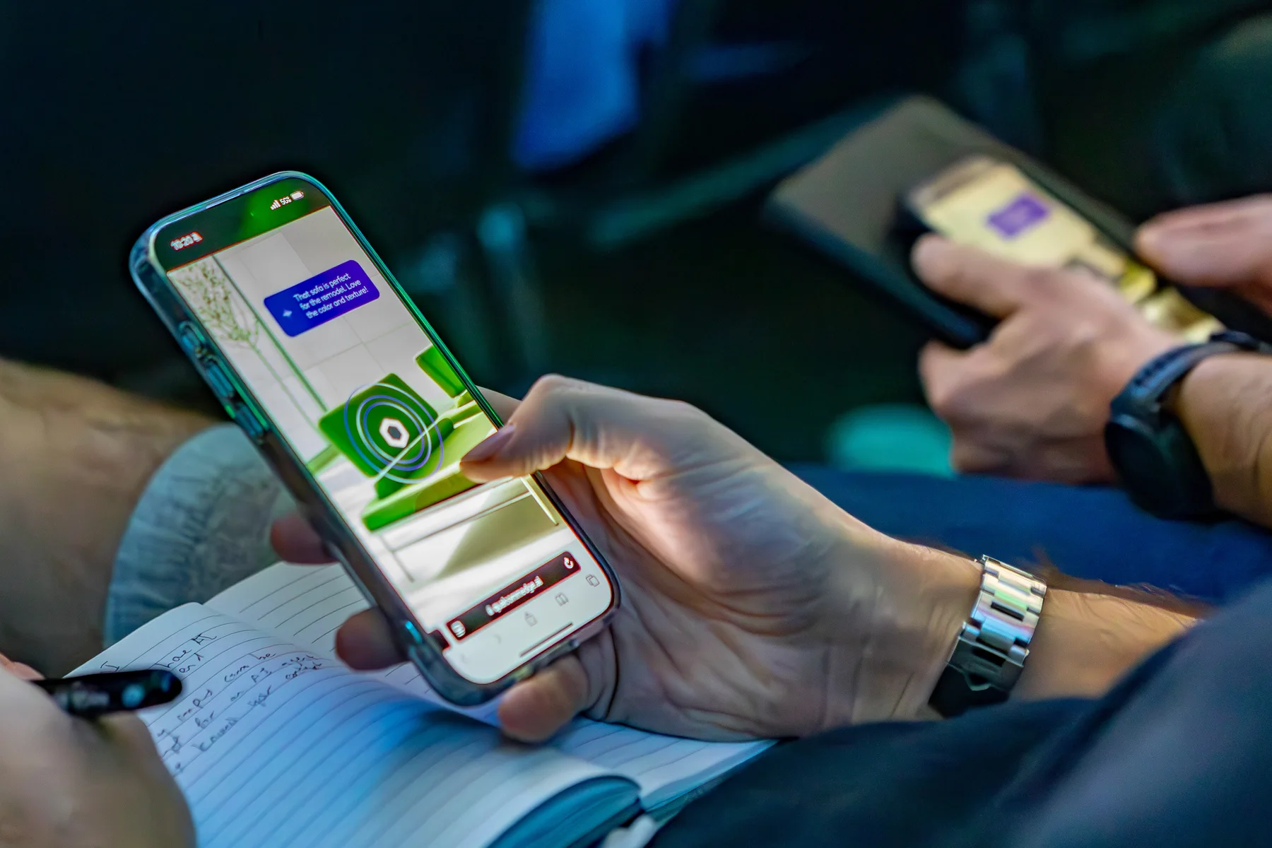 An attendee uses the mobile furniture shopping interface during the keynote.