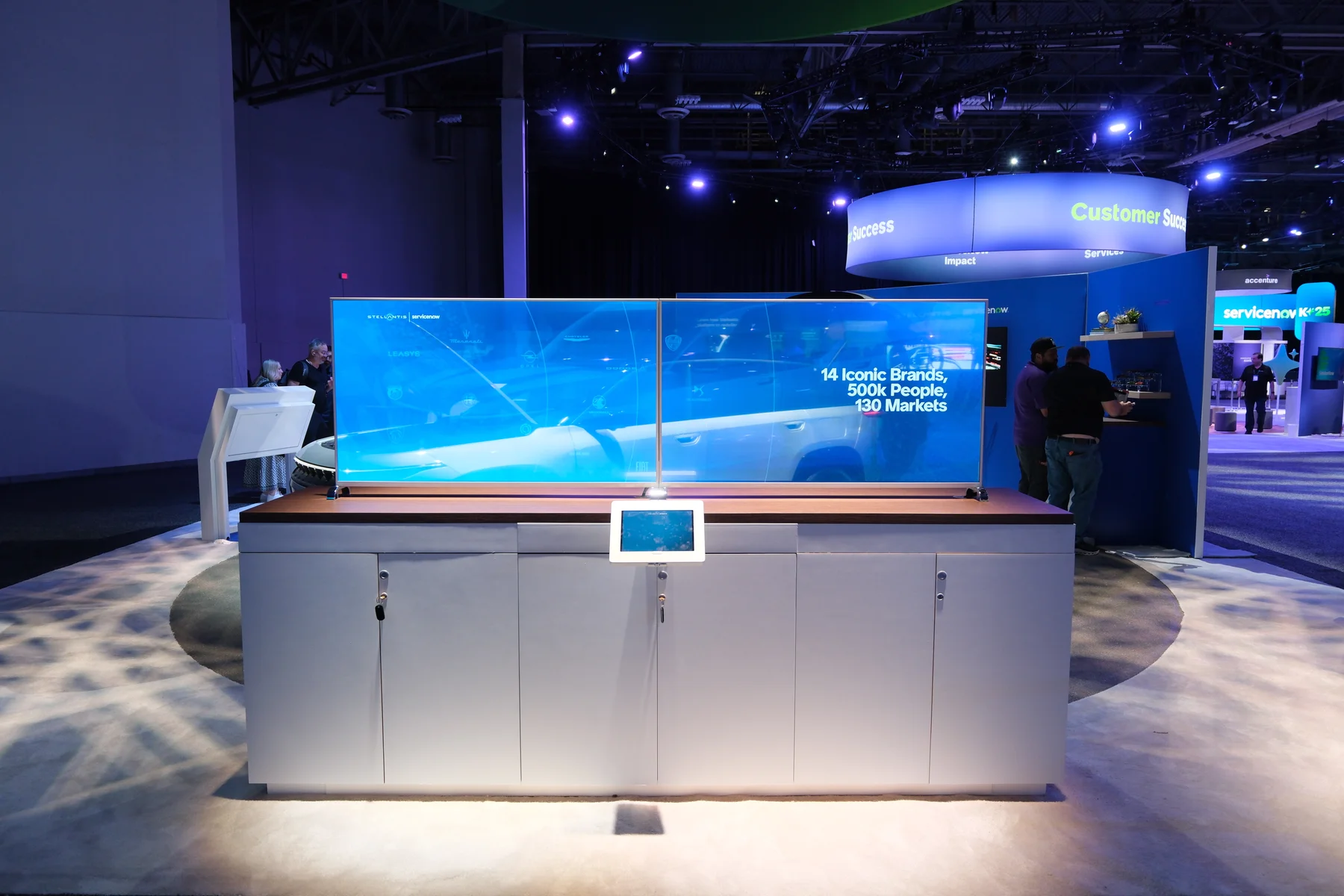 The wide exhibition screen and its nearby control tablet.